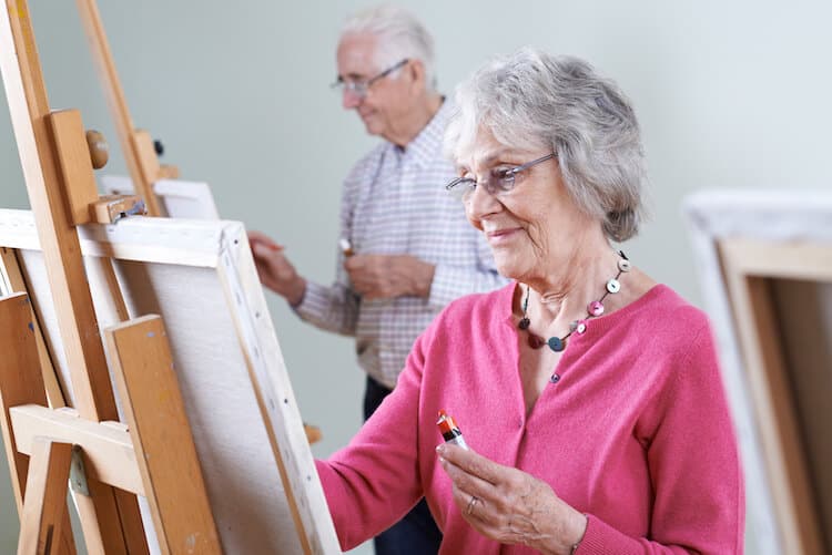 Seniors enjoying a painting class.
