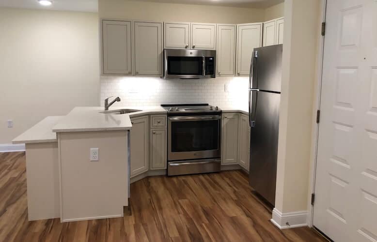 An apartment kitchen with new design upgrades and flooring