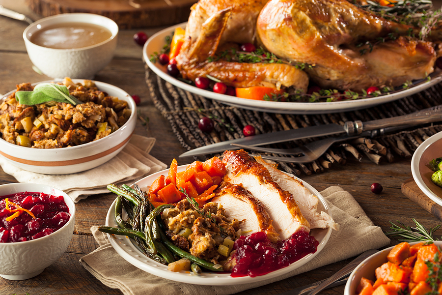 A table is filled with fresh Thanksgiving foods.