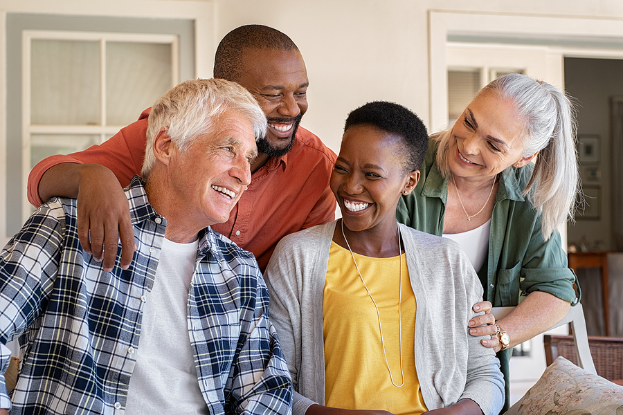 Diverse group of seniors smiling at each other