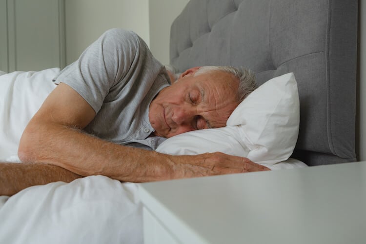 Senior man sleeping in bed.