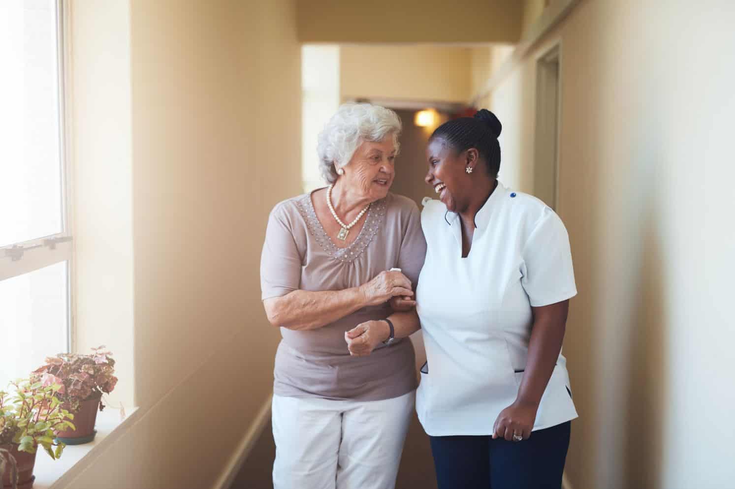 Life Plan Community team member giving a tour to a senior woman.