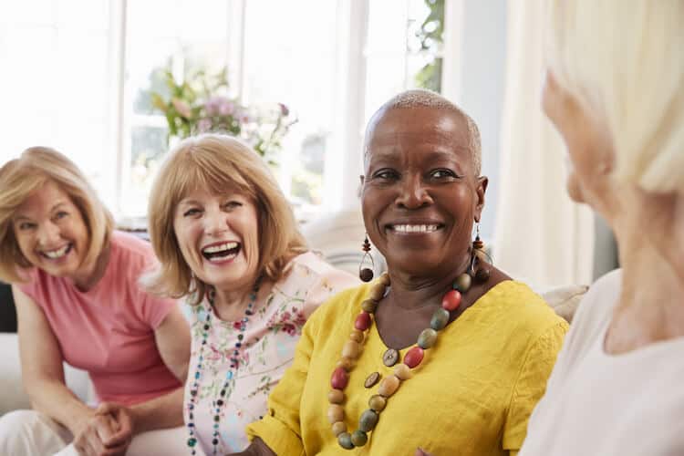 Group of senior female friends laughing.