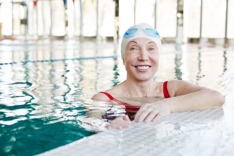 Senior woman swimming in a pool.