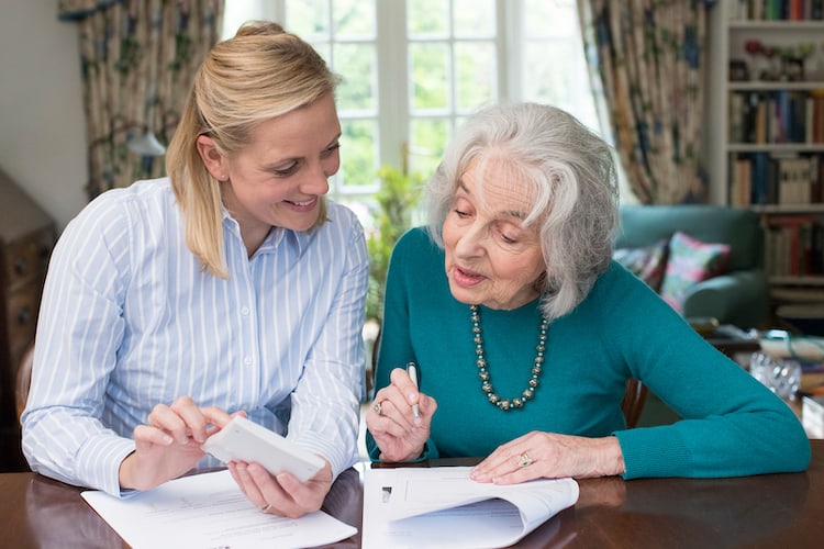 Senior woman paying bills.