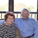 senior couple smiling on couch
