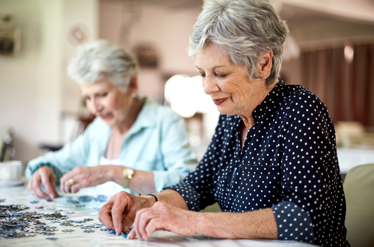 Senior friends completing puzzle