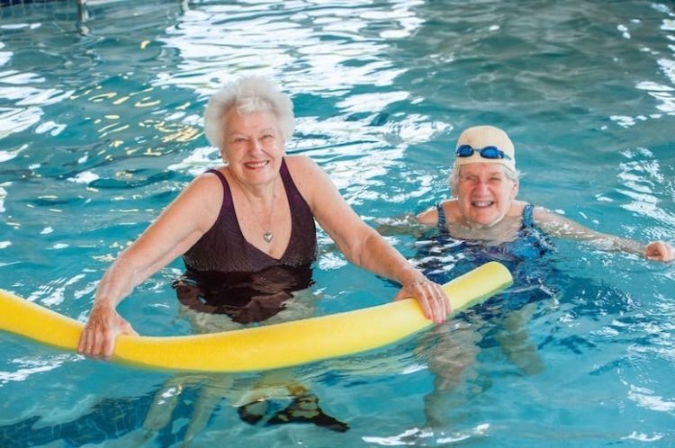 Senior friends swimming in the pool
