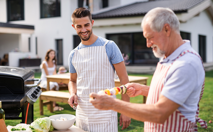 Kebabs are prepared for the grill by father and son