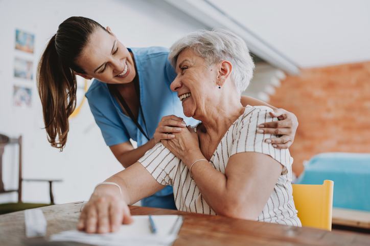 Senior receiving help from caregiver while planning future