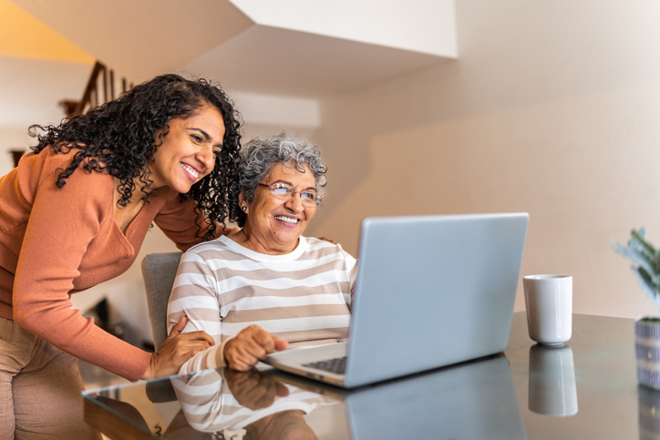 Senior planning future with daughter on computer