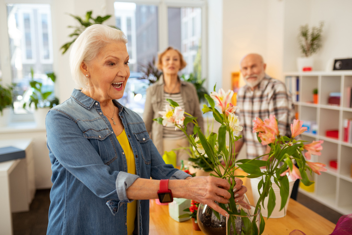 Senior putting her flowers in a vase
