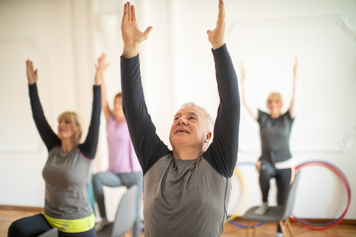 Senior enjoying yoga class