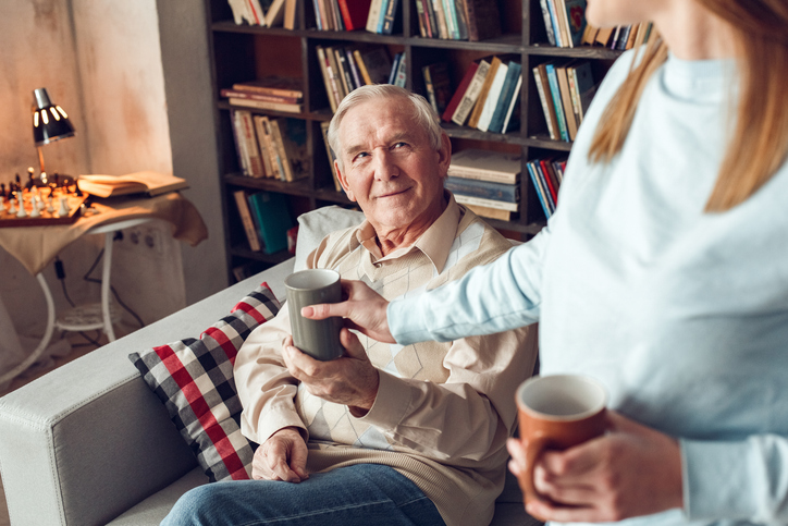 Senior being served a cup of coffee