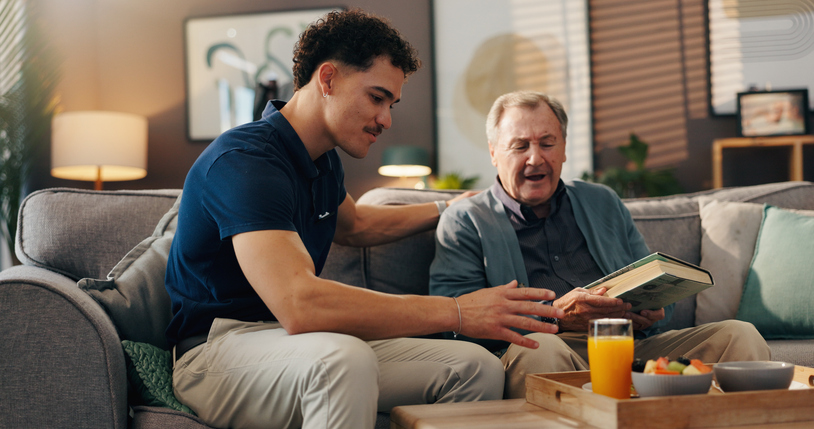 Caregiver helping senior read