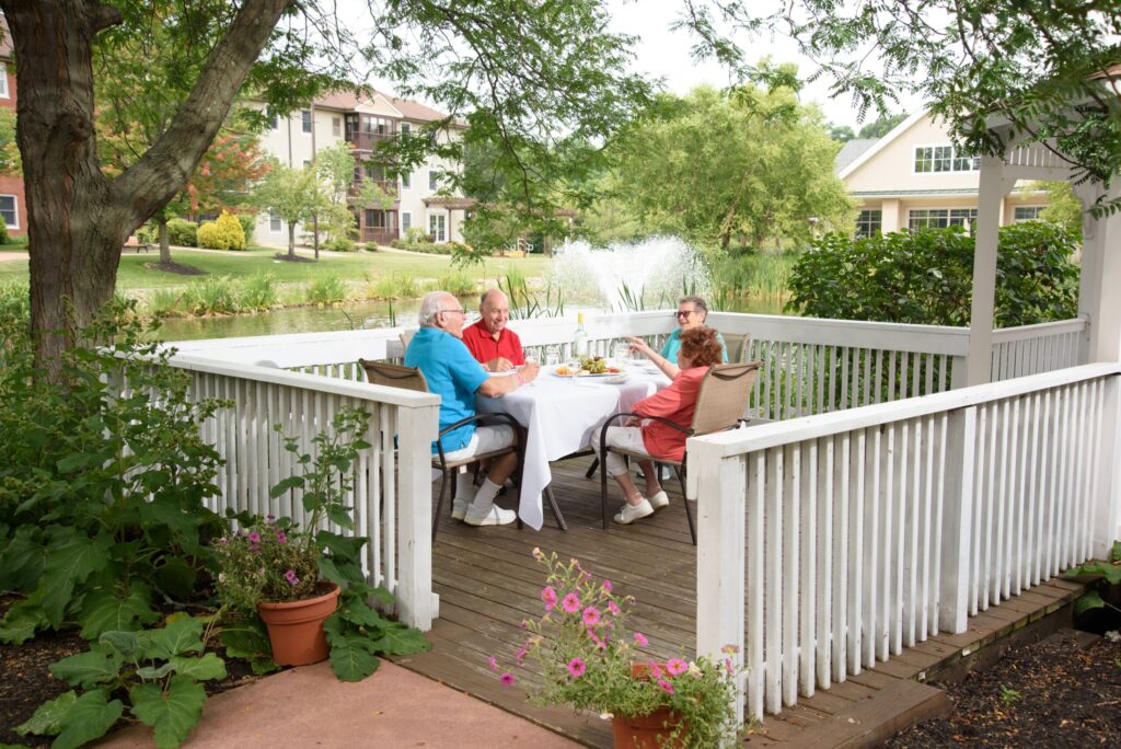 Seniors eating dinner on pond