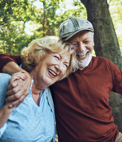 Seniors hugging in nature