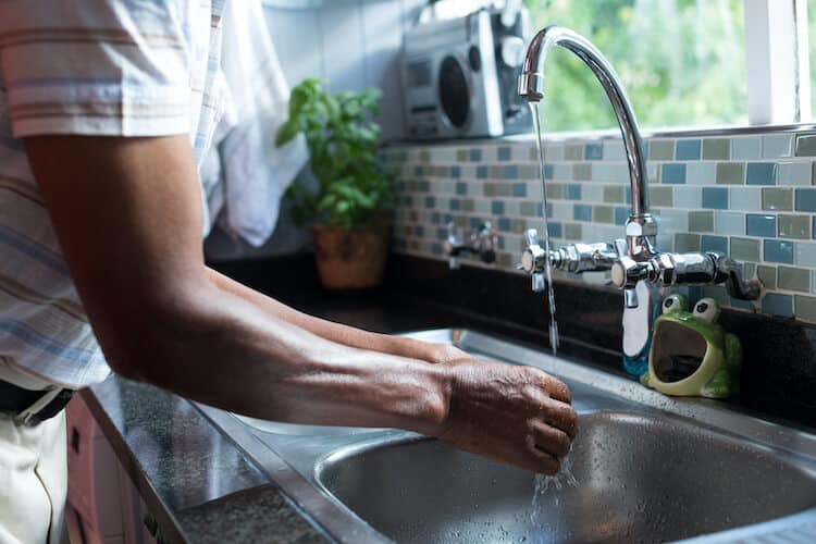 Senior maintaining good personal hygiene by washing their hands.