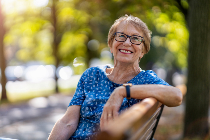 Senior happily glancing on bench