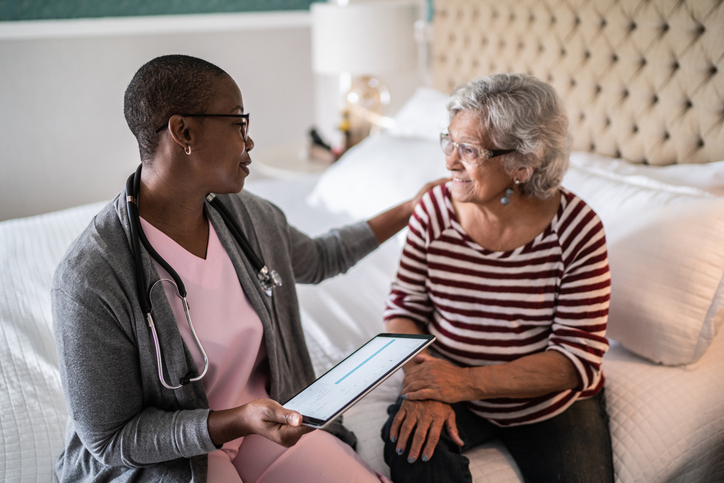 Senior caregiver giving advice to senior