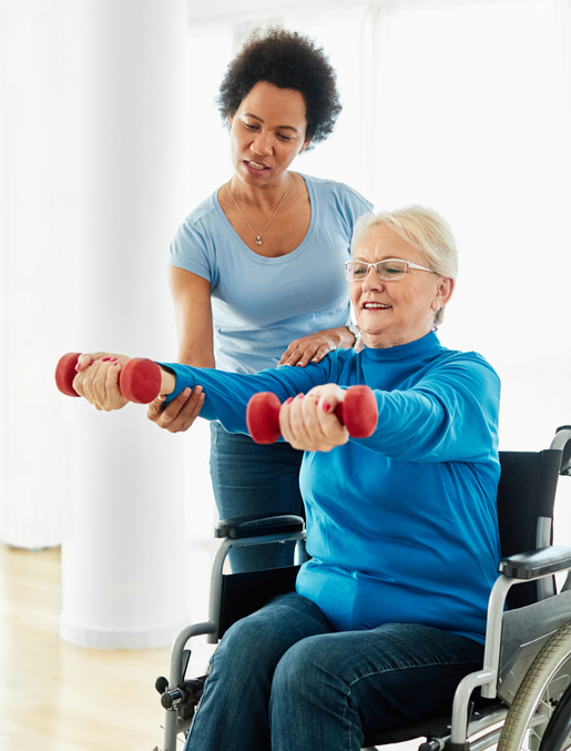 Senior exercising with caregiver