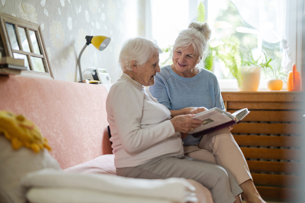Senior reading with her younger friend