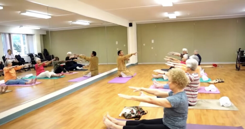 seniors doing yoga on the ground